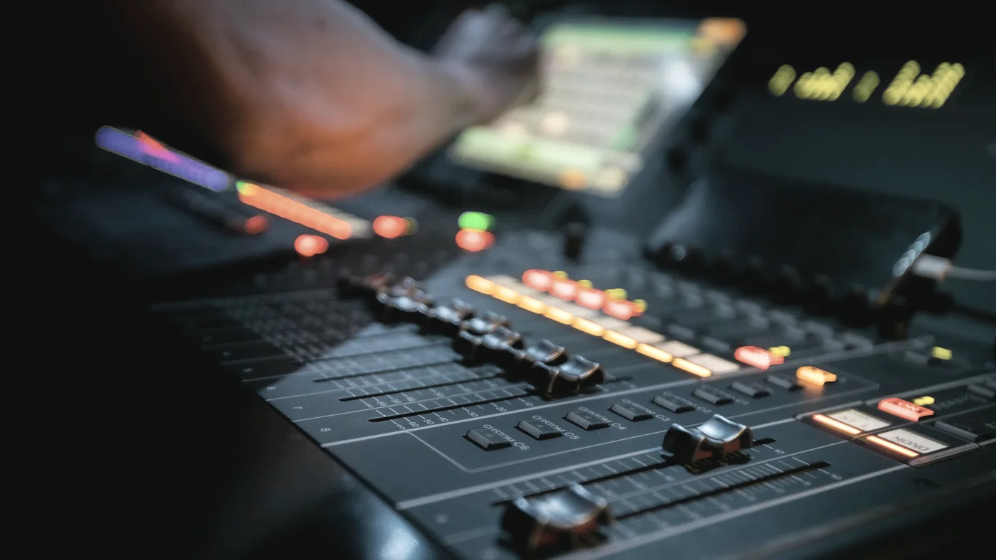 Hands on the console during a mix